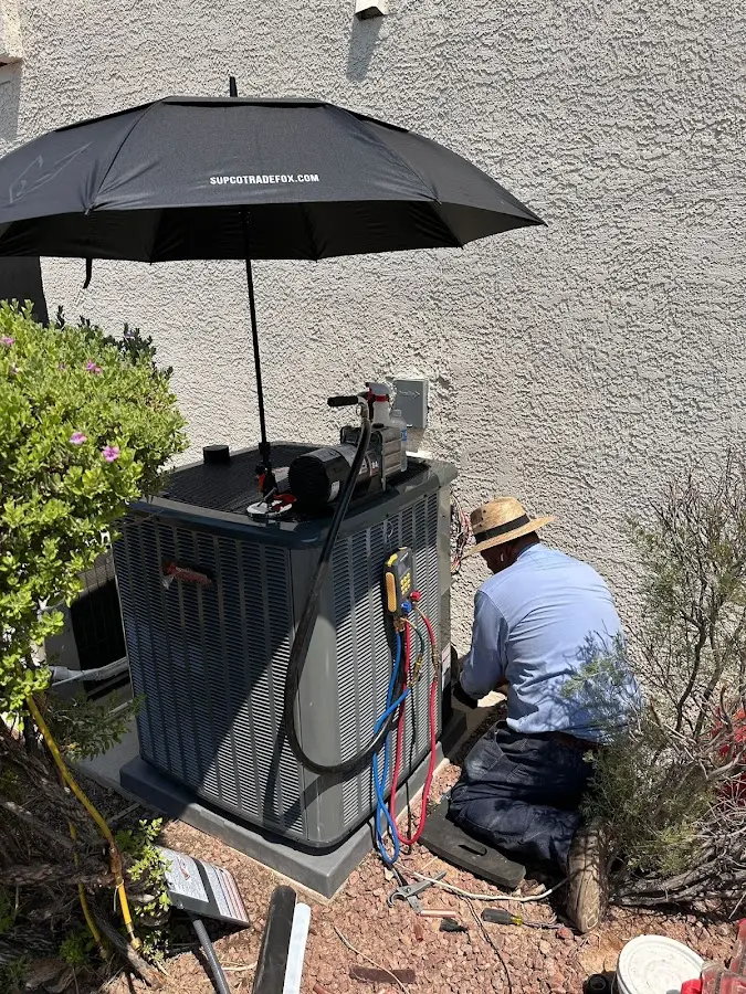 HVAC technician performing outdoor AC maintenance in Chillicothe